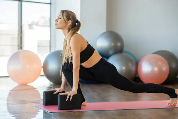 Woman performing yoga pose for flexibility and wellness at Herspace Fitness Studio