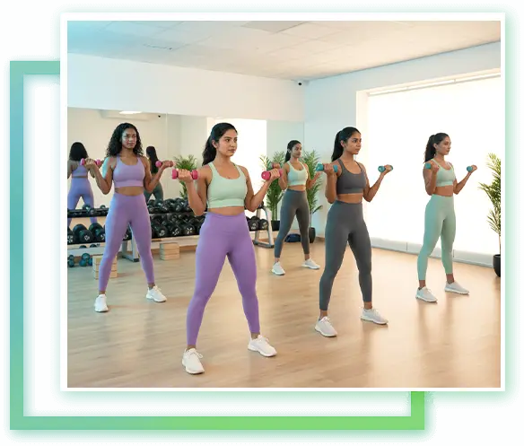 Group of women performing fitness training in a modern studio in Kelambakkam